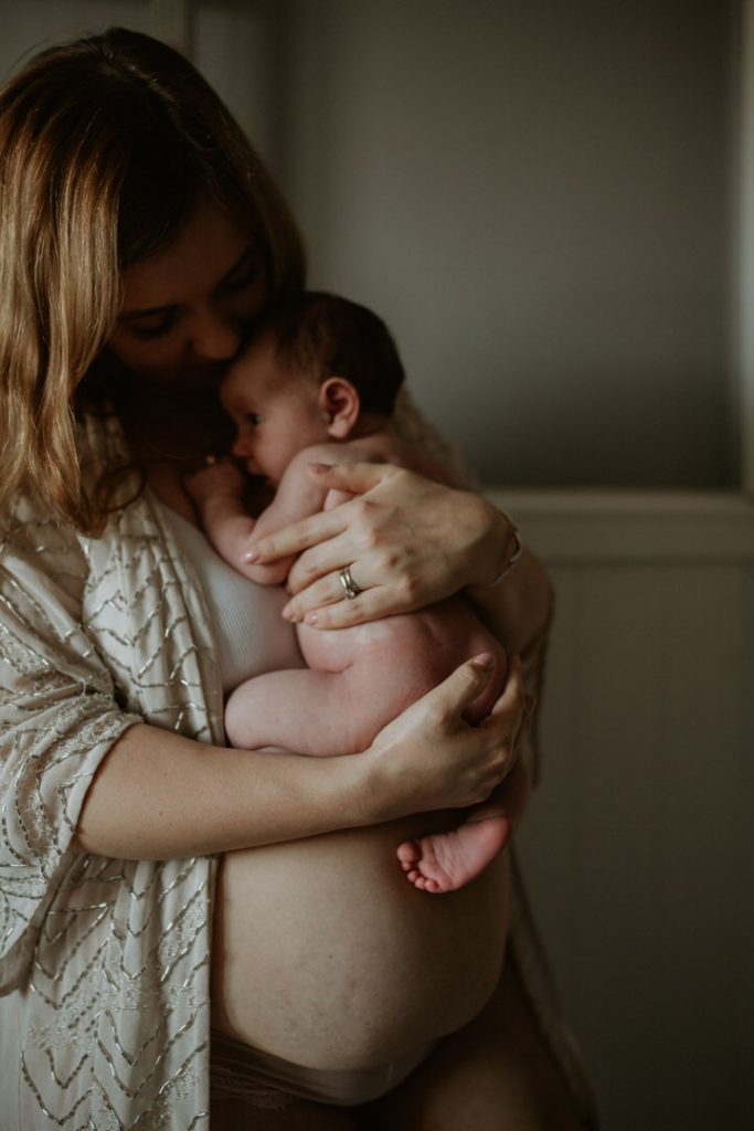 Photo of mother holding newborn